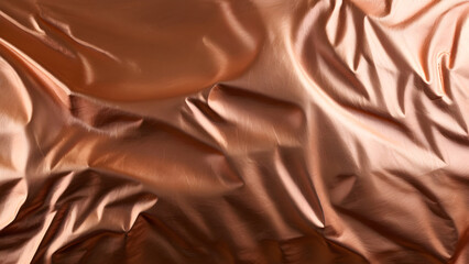 Naklejka premium Copper metallic silk satin folded fabric background.