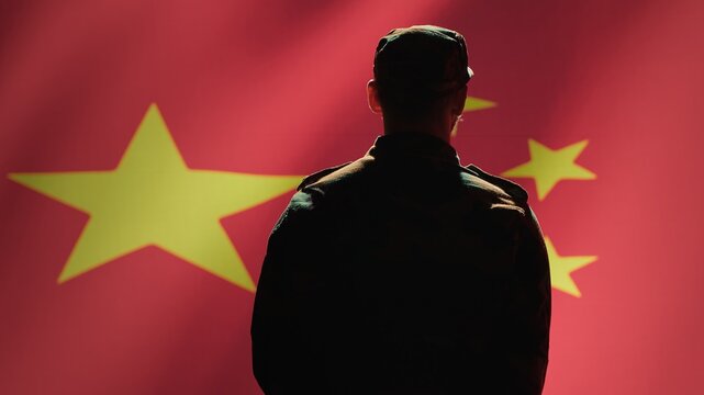 Member of chinese army doing saluting hand gesture towards China flag in command center, showing respect. Military unit in uniform serving Chinese Communist Party, doing honoring gesturing, camera A