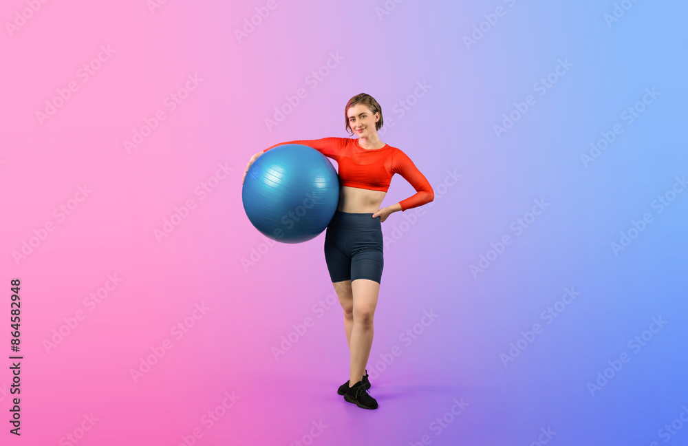 Wall mural Full body length gaiety shot athletic and sporty young woman with fitness exercising ball in standing posture on isolated background. Healthy active and body care lifestyle. - Wall murals