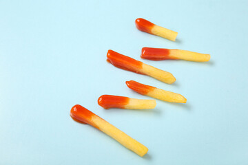 Tasty french fries with ketchup on blue background