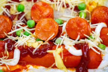 Traditional Brazilian style hot dog with sausage, peas and straw potatoes