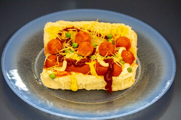 Traditional Brazilian style hot dog with sausage, peas and straw potatoes