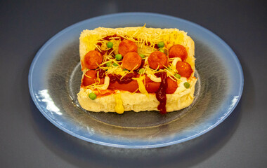 Traditional Brazilian style hot dog with sausage, peas and straw potatoes