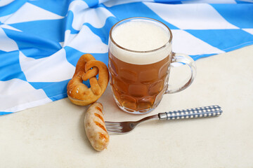 Mug with beer, tasty sausage, pretzel and flag of Bavaria on white background. Oktoberfest celebration