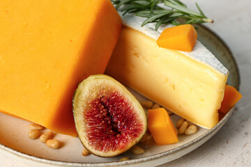 Plate with tasty cheese on table, closeup