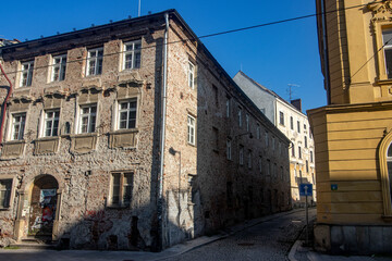 Fototapeta premium An old and decaying tenement house on a street corner