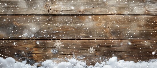 Snow blankets an aged wooden board, creating a Christmas winter backdrop with ample copy space image.