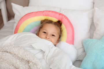Cute little girl lying in bedroom, closeup