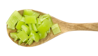 Fresh green paprika in wooden spoon, chopped pepper isolated on white, top view