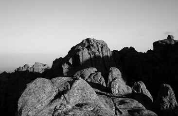 Black and white shot of the rock massif The Giants in Cordoba, Argentina. View of the rocky hills at sunset.