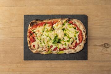 Margherita, A classic Italian pizza made with tomato sauce, fresh mozzarella cheese, fresh basil and a drizzle of olive oil