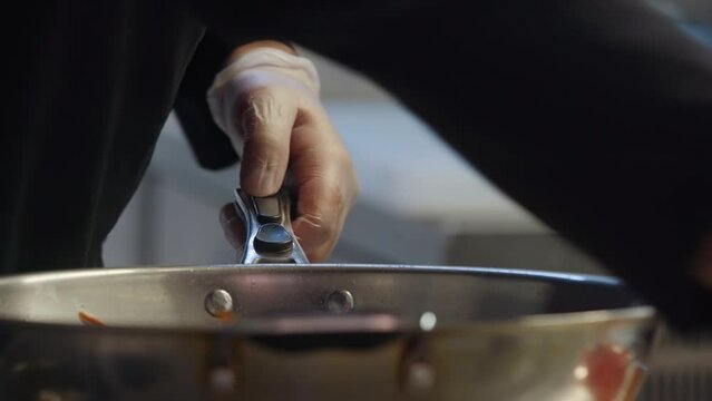 A chef is preparing the vegetables ingredient using the frying pan. Chef is Mixing the fried vegetables inside of the frying pan. A chef adding delicious sauce into the frying pan with the vegetables.