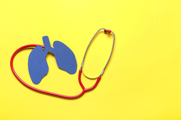 Blue paper lungs with stethoscope on yellow background