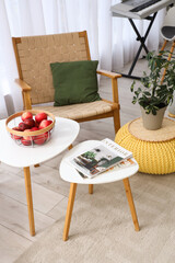 Interior of living room with armchair and tables