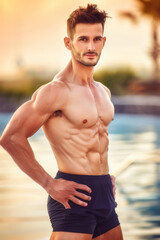Fototapeta premium A man with a muscular body is posing for a picture in a pool, athletic fit people