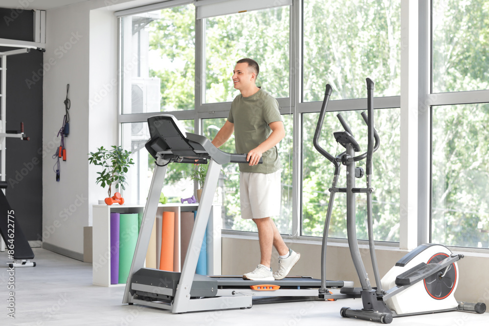 Canvas Prints sporty young man training on treadmill in gym