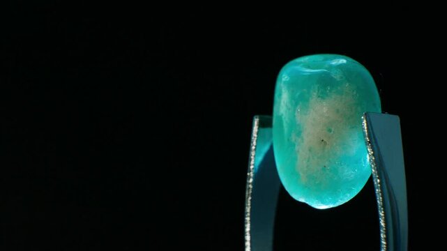 Amazonite (KAlSi3O8), blue-green gemstone, symbolizes hope and harmony. Non-magnetic, 6-6.5 on Mohs scale. Composed of potassium feldspar. Valued for soothing anxiety, enhancing communication