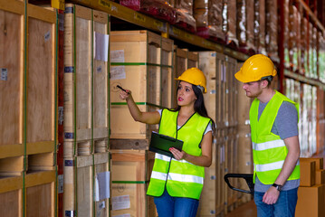 Caucasian man and woman warehouse worker working and checking inventory stock on parcel shelf in distribution fulfillment center. Business industry and freight transportation logistic cargo concept.