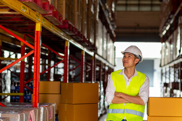 Portrait of Asian man warehouse worker engineer employee working and checking inventory stock on parcel shelf in distribution fulfillment center. Freight transportation logistic cargo industry concept