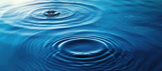 Blue water texture with ripples and rings - spa concept background with copy space.