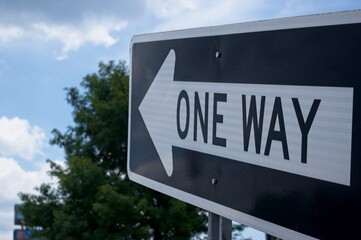 One way sign pointing skyward