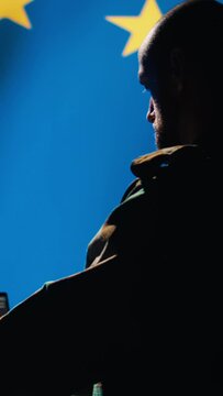 Vertical video EU alliance engineer protecting against fake accounts on social media promoting totalitarian governments interests. Technician working for European Union doing cybersecurity job, camera