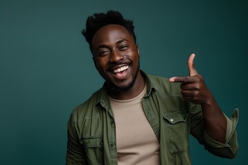 Smiling Black Man Pointing in Green Shirt

