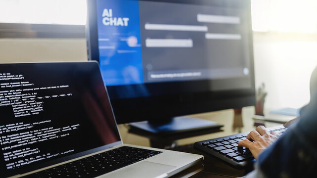 AI chat bot, Programmer using generative artificial intelligence for software development inside office. Virtual chatBot technology trend - Powered by Adobe
