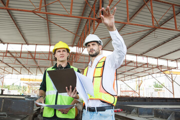 Construction engineers team working - discussing together.