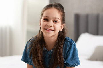 Portrait of happy little girl indoors. Cute child