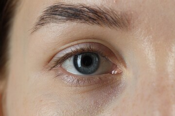 Fototapeta premium Woman with beautiful blue eyes, macro photo