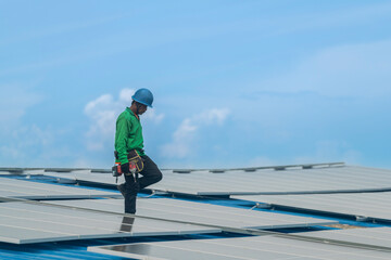 Worker Technicians are working to construct solar panels system on roof. Installing solar photovoltaic panel system. Men technicians walking on roof structure to check photovoltaic solar modules.