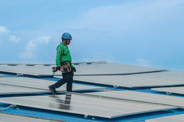 Worker Technicians are working to construct solar panels system on roof. Installing solar photovoltaic panel system. Men technicians walking on roof structure to check photovoltaic solar modules.
