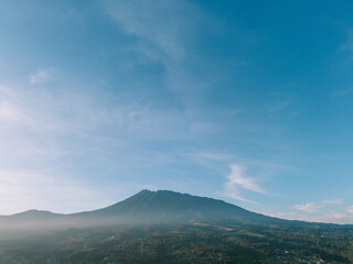 Obraz premium Morning view of Mount Gede with light mist and bright clouds, capturing serene and clear beauty