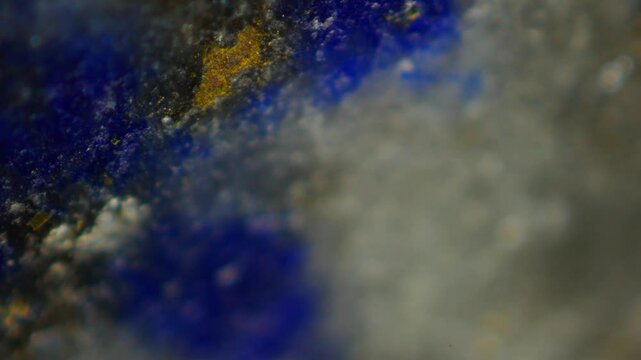 Lapis Lazuli, deep blue with gold flecks under microscope, is prized since antiquity. Chemical formula: (Na,Ca)8(AlSiO4)6(SO4,S,Cl)2. Non-magnetic, hardness 5-6 on Mohs. Composed of lazurite, calcite