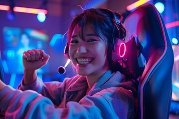 Excited young woman gamer wearing a headset and celebrating victory while playing video game. Woman enjoying esports and competition.