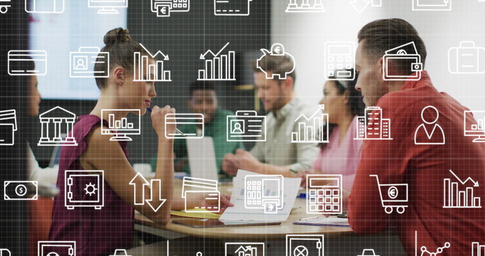 Image of multiple icons over diverse coworkers discussing reports in office