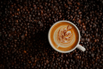 Beautiful hot latte, coffee beans background, in a cozy coffee shop.