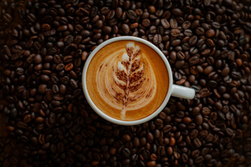 Beautiful latte, coffee beans background, in a cozy coffee shop