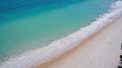 a photograph of an aerial view of a sandy beach with a blue ocean and a white sand beach