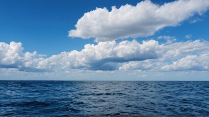 Obraz premium large body of water with a blue sky in the background and some clouds in the sky