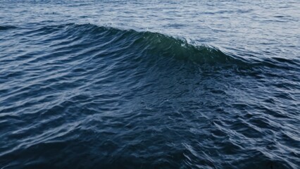 Fototapeta premium close up of a body of water with a wave coming up from the water
