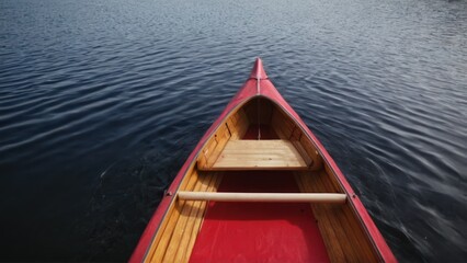 red canoe with two wooden oars on the front and a paddle on the back