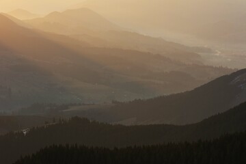 Dawn in the Ukrainian Carpathians with fog on the mountain slopes