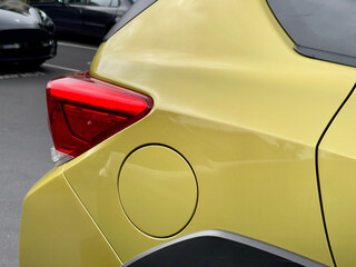 The taillight and gas cap of a green car