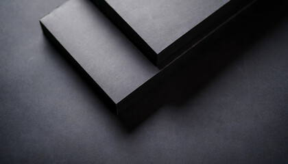 Abstract geometric composition featuring black paper shapes. Minimalist design with overlapping forms and sharp lines. Evokes themes of modernity, simplicity, and sophistication in a stark monochrome 