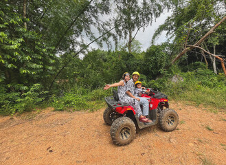 Fototapeta premium Child riding a quad bike outdoors for fun and adventure