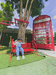 Children playing happily on a colorful playground in a sunny park filled with slides, swings, and other fun equipment under a bright blue sky
