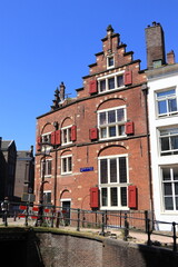 Obraz premium Amsterdam Oudezijds Achterburgwal Old Brick House Facade with Stepped Gable, Netherlands