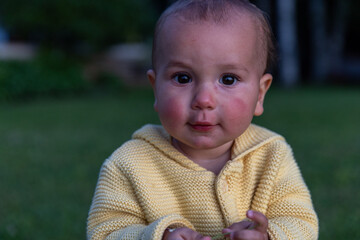 Toddler girl outside at sunset looks towards camera - cute 